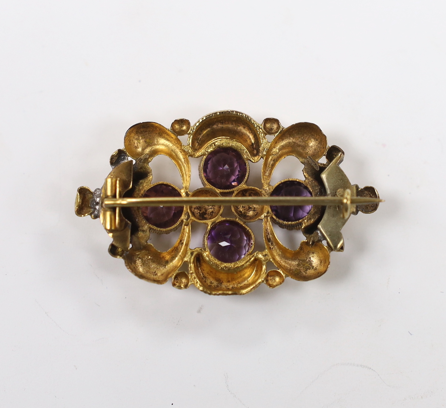 A late Victorian yellow metal and amethyst cluster set oval brooch, 45mm, gross weight 7.2 grams.